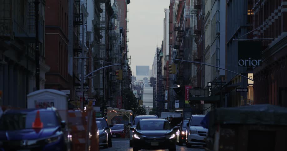 Vehicles parked and moving on a city street