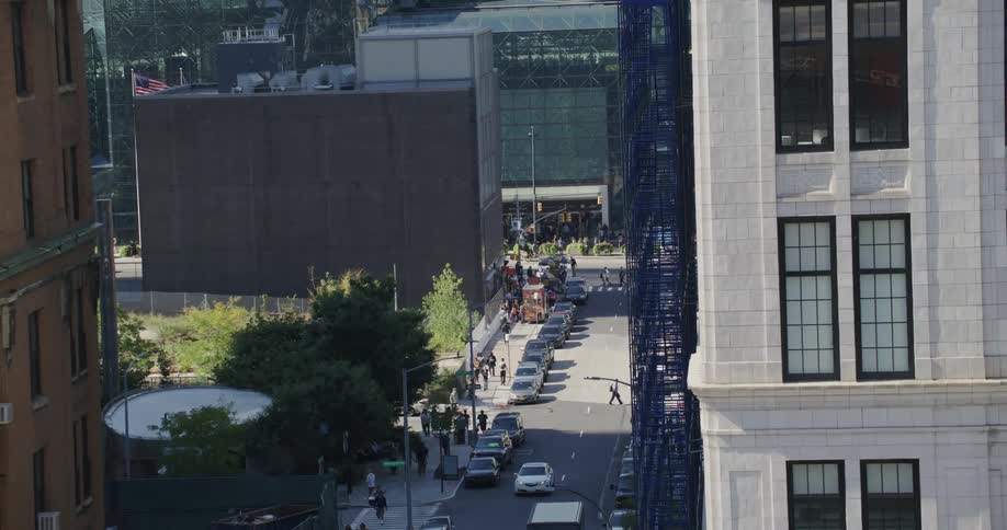 Cars and pedestrians on a city street at daytime