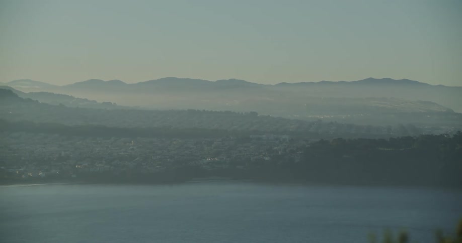 Aerial of the beach coast in a city with mountains
