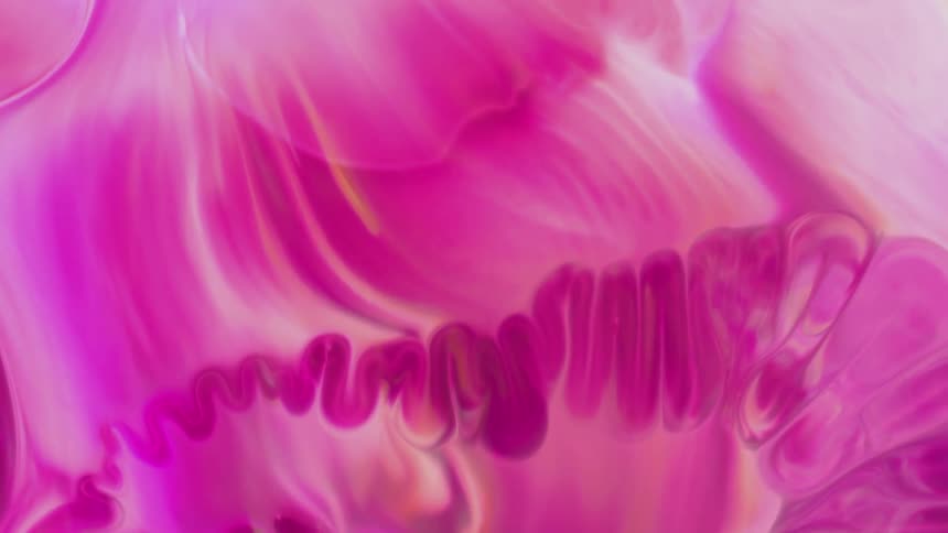 A swirling mass of pink purple and yellow marble on a white background