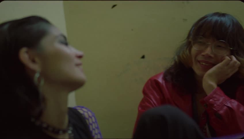 Tired friends sit and lean against walls while talking