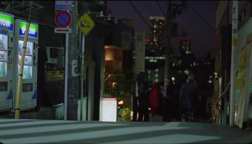 Group of friends walking on the city streets at night