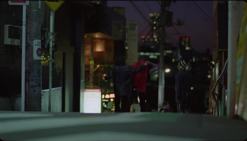 Group of friends walking on the city streets at night