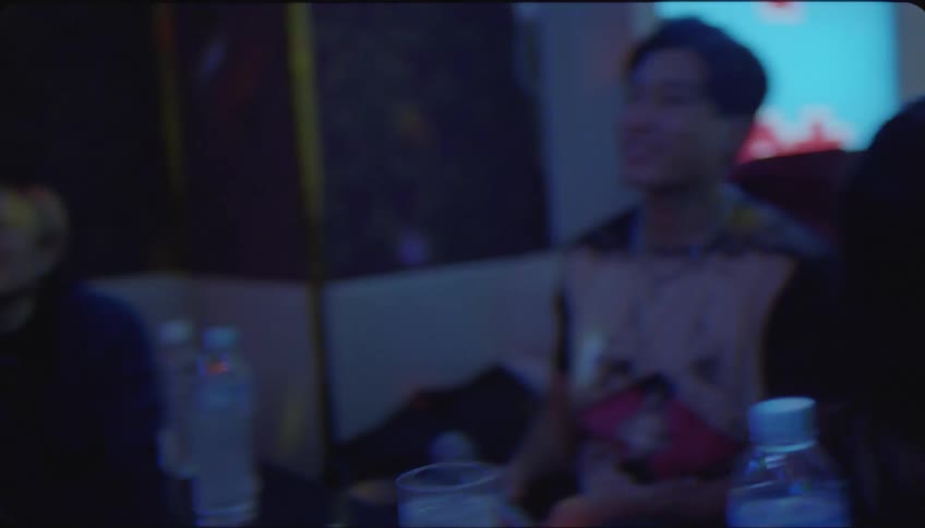 Friends in a nightclub singing karaoke