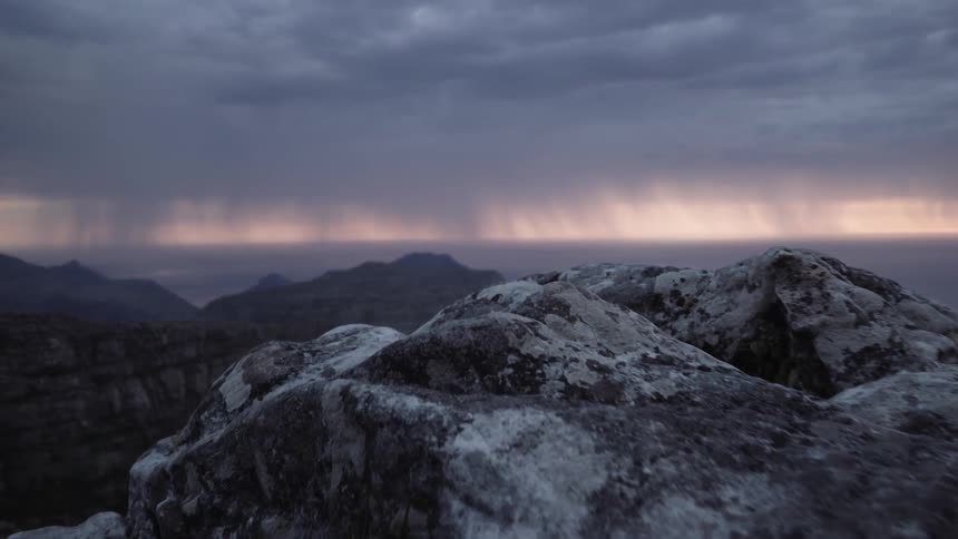 A rocky path on a cliff on a cloudy day