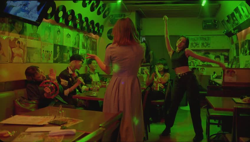 Friends sing and dance in karaoke club
