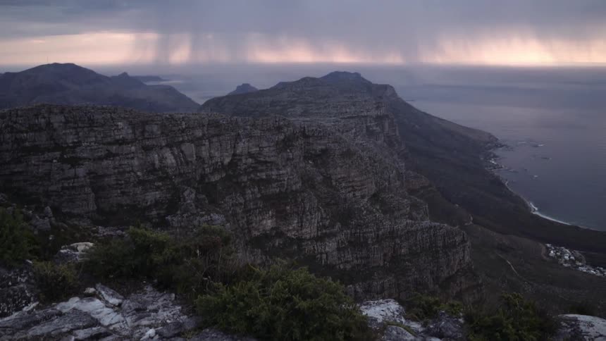 Trees and large rocks cover this mountain top
