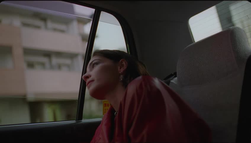 Woman in the back seat of a car looking at the city view