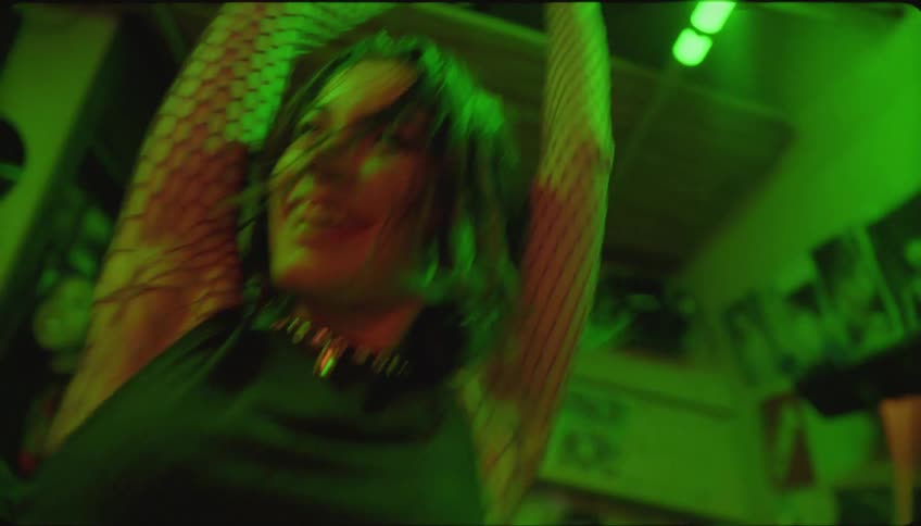 A woman is dancing while other women listen to music in a night club