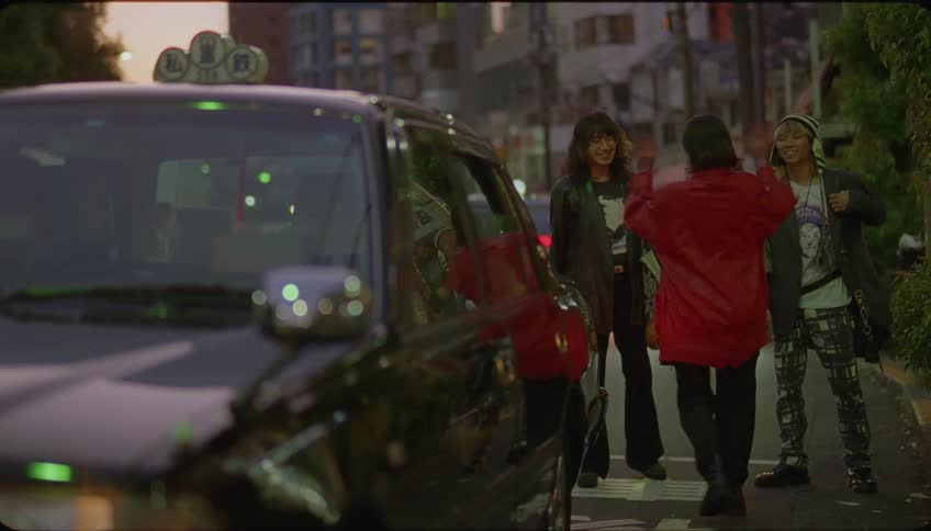 Woman saying goodbye to her friends and getting into a taxi