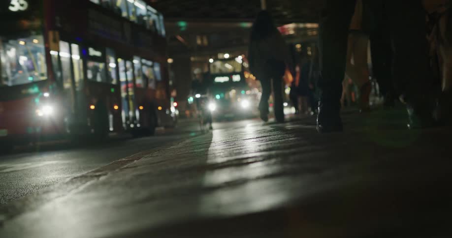 Pedestrians and vehicles on the city streets at night
