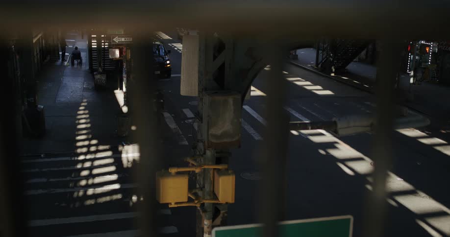 Cars travel under the train overpass
