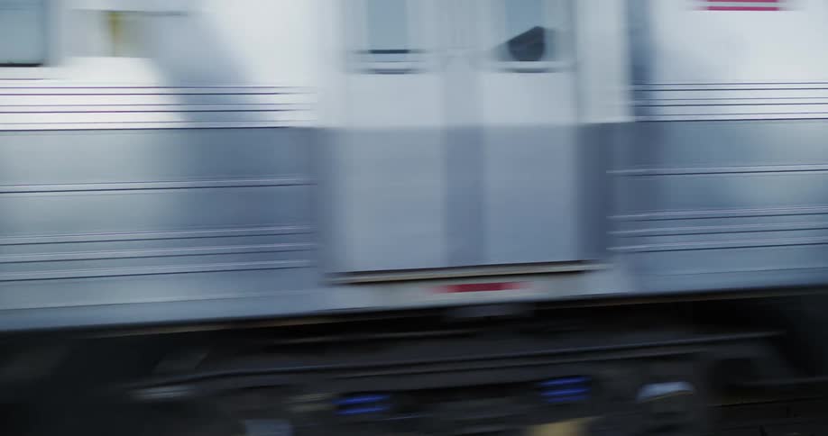 Cars and metro trains crossing a bridge in the city