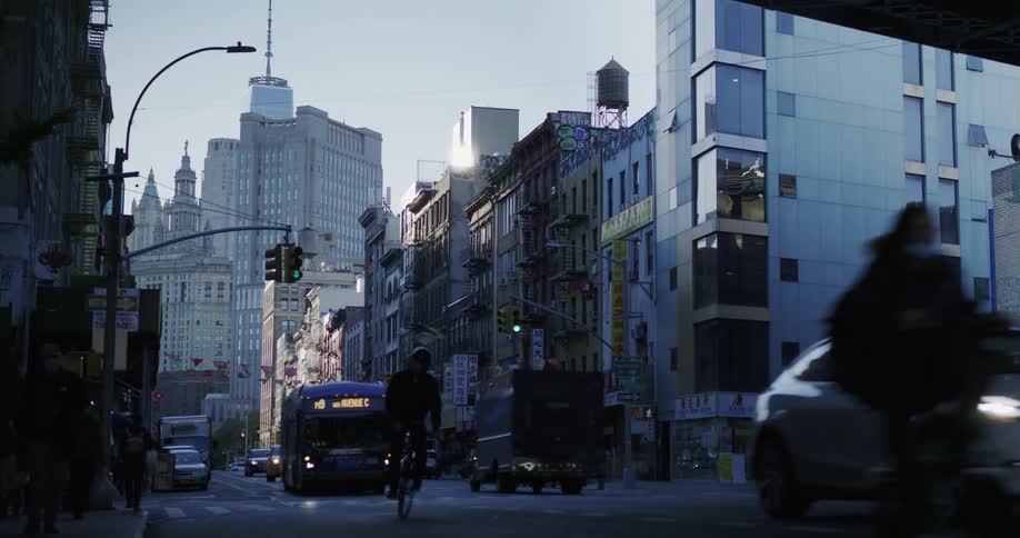 View of a street in a metropolis with a bus stopping at a bus stop