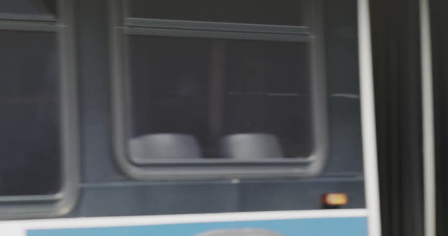 Bus passing in front of a bridge with stationary vehicles