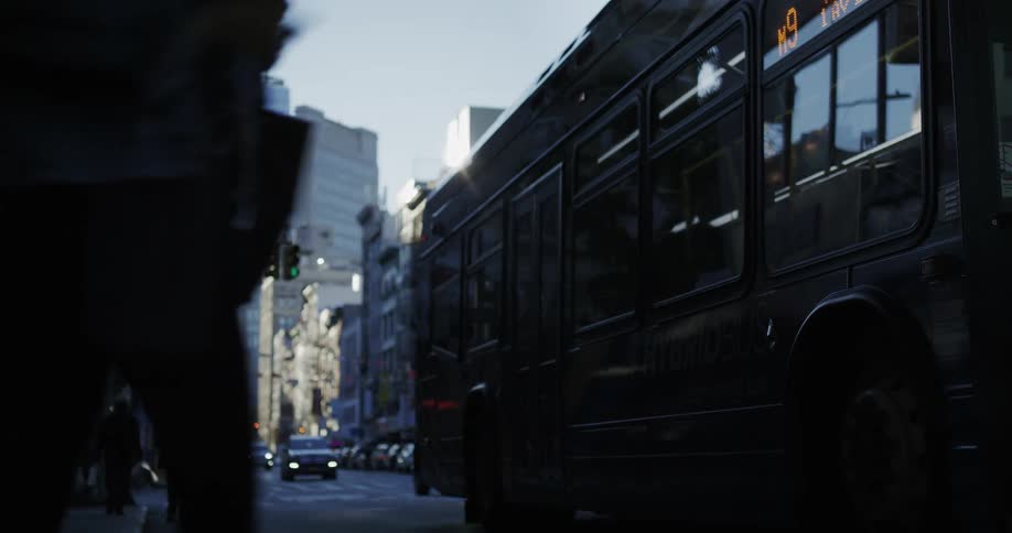 People getting on bus in the city street