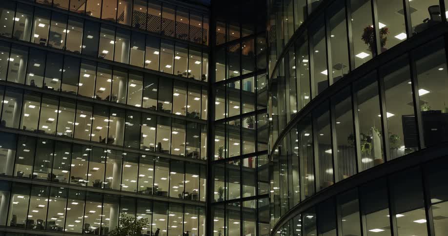View of a building with mirrored architecture at night