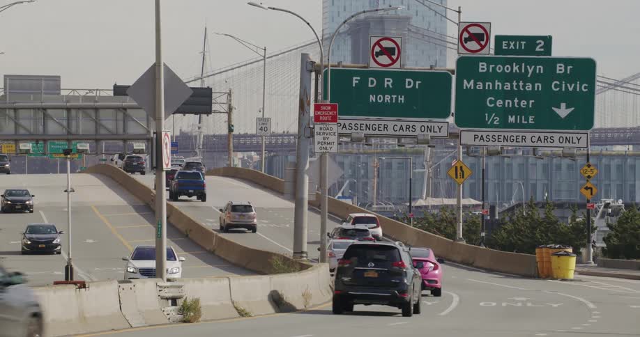 Traffic runs on the freeway by the city