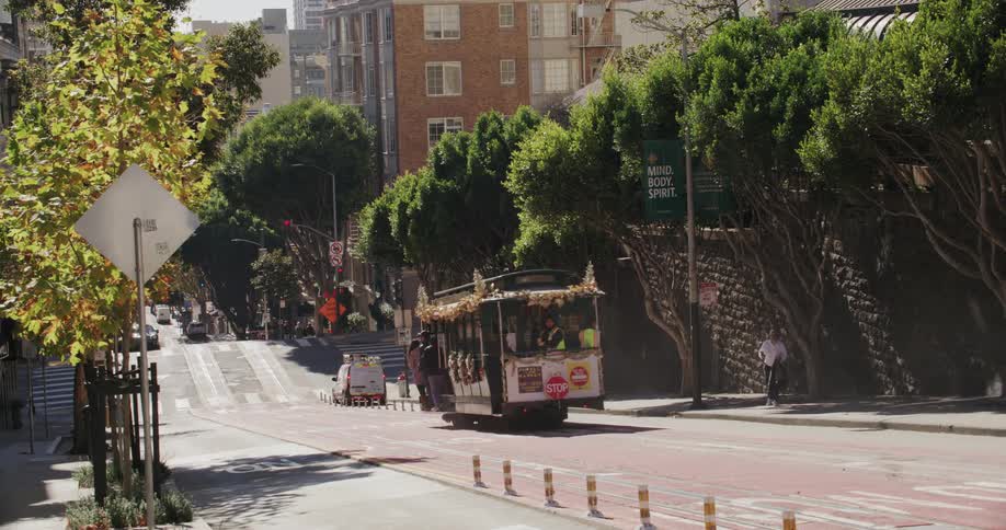 Trolley car moving down a street in the city
