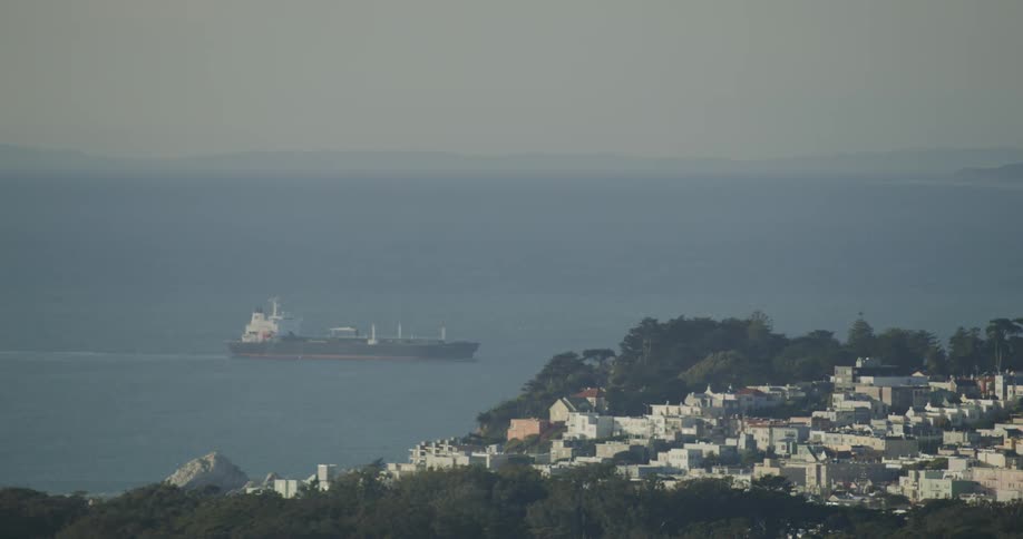 Oil tanker in the sea near a coastal city