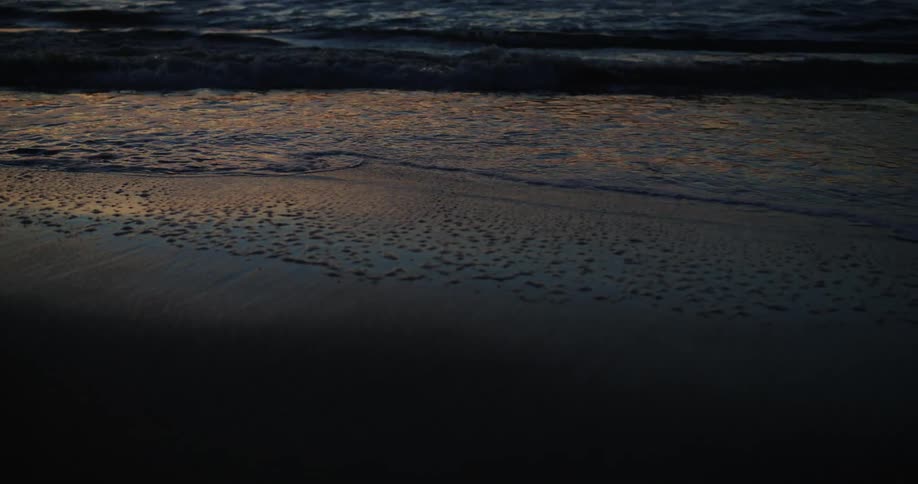 Shoreline of a beach at sunset