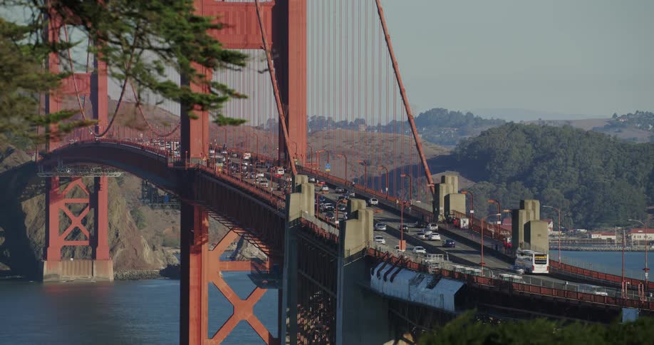 View of a bridge over the sea with vehicles moving
