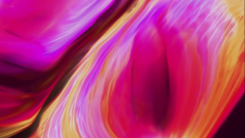 Extreme closeup of a dense and psychedelic colored fluid in motion