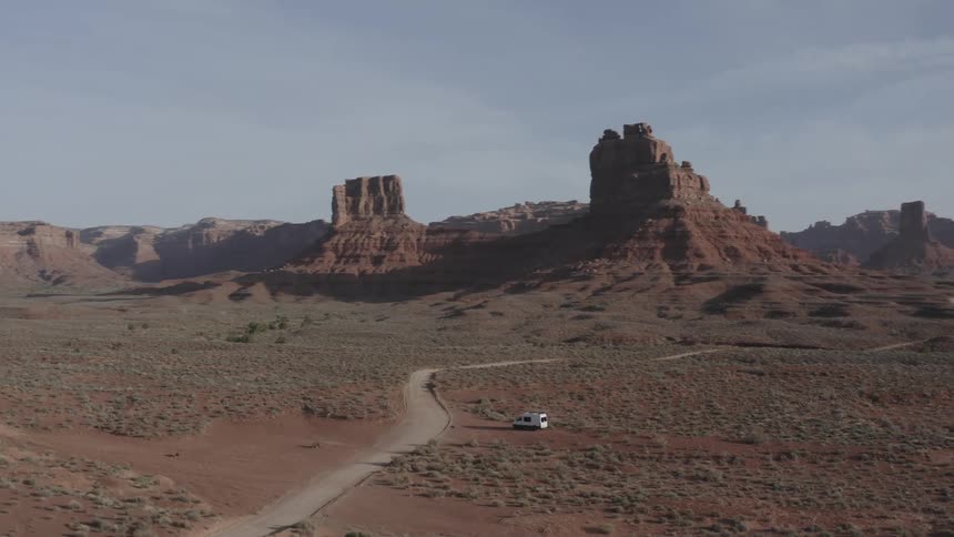 Aerial panorama of a motorhome amidst canyons
