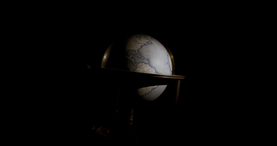 Earth globe spinning in a dark room