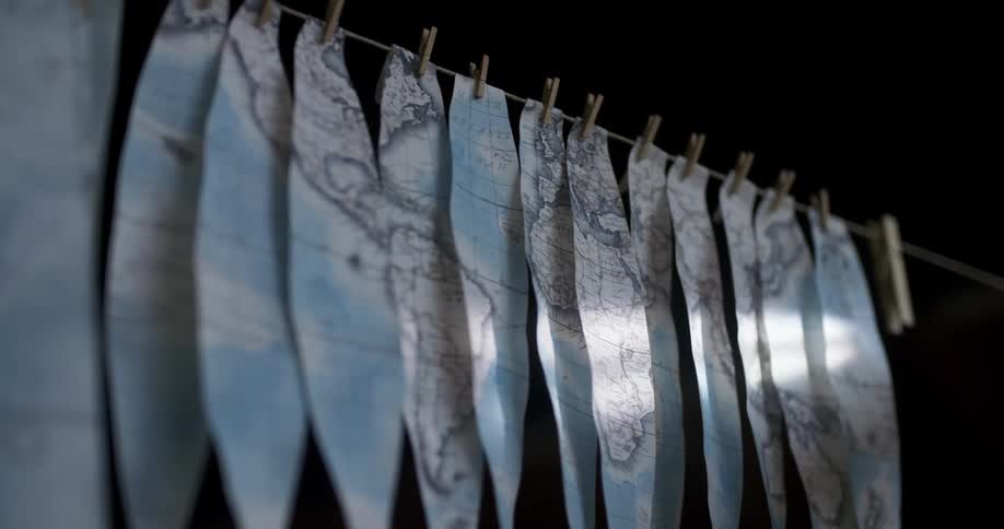 Pieces of a map are drying on the clothesline