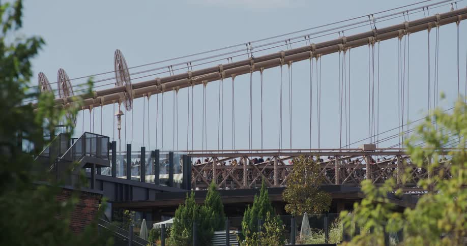 A car drives past the crowd on the bridge