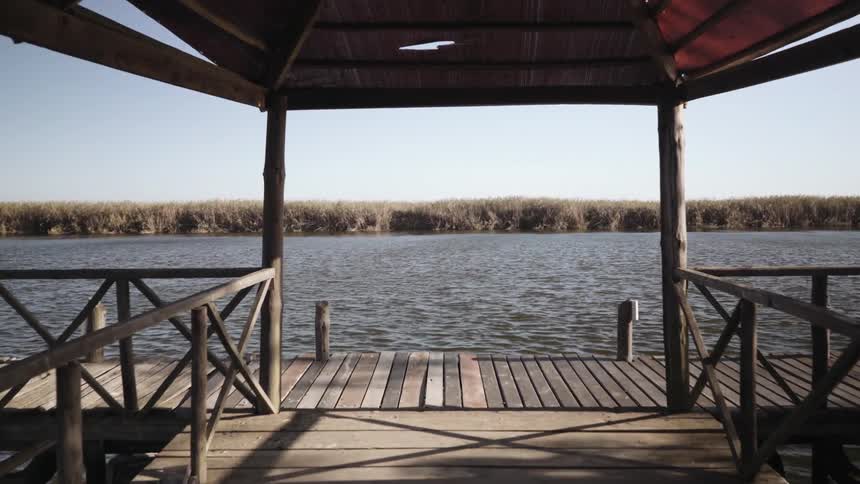 A small pier has rough water around it