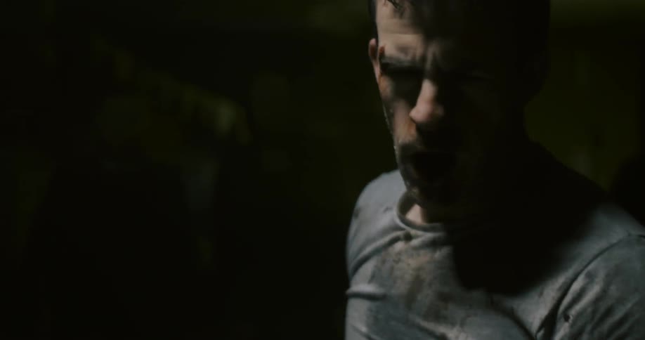 A man with a bloodied face stands up and breathes heavily