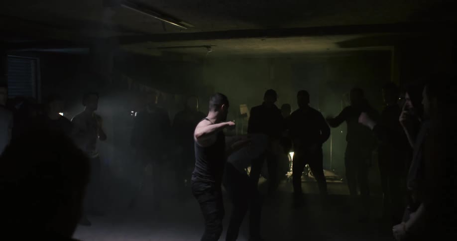 People watch as two people fight