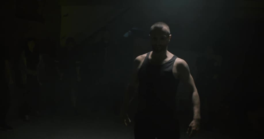 A man in black punches another man