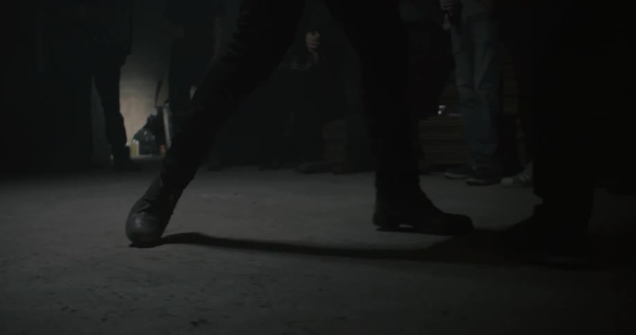 Two people are fighting on a concrete floor