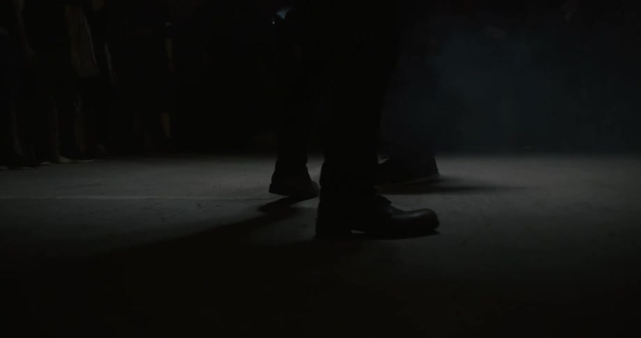 Two people are fighting in a dark room
