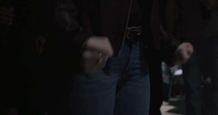 A woman shakes her fists and opens them