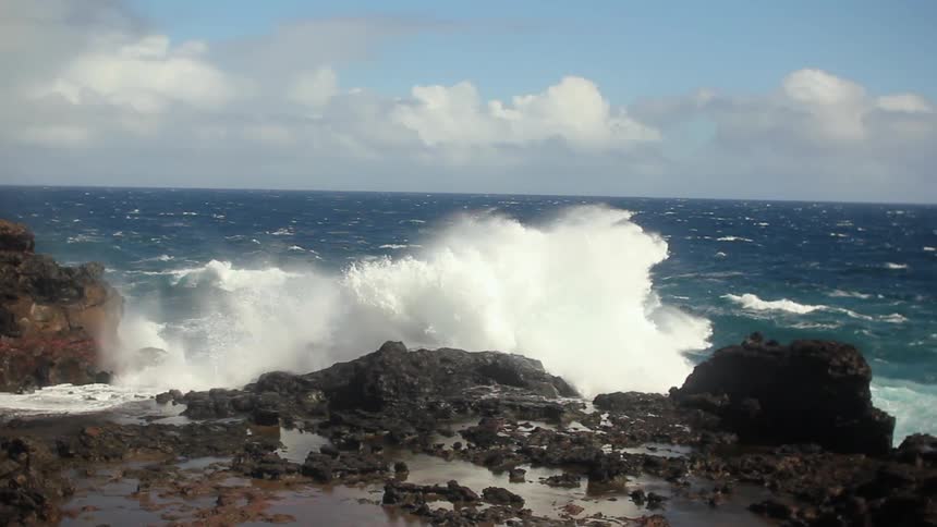 Ocean waves crash into a rocky shore