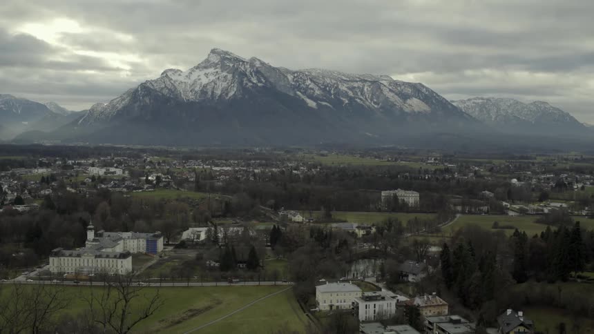 A city near a mountain on a cloudy day