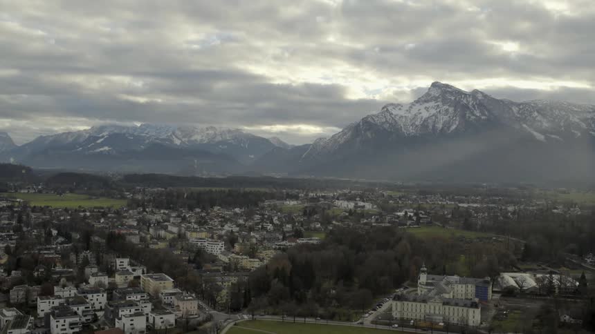 Heavy clouds move over the mountains and town below