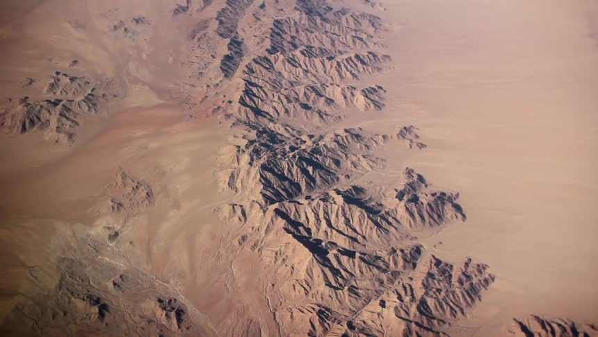The desert below has ridges with hills all over