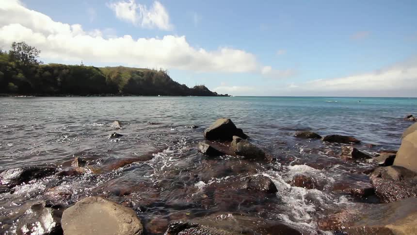 Ocean water ripples around a rocky shore