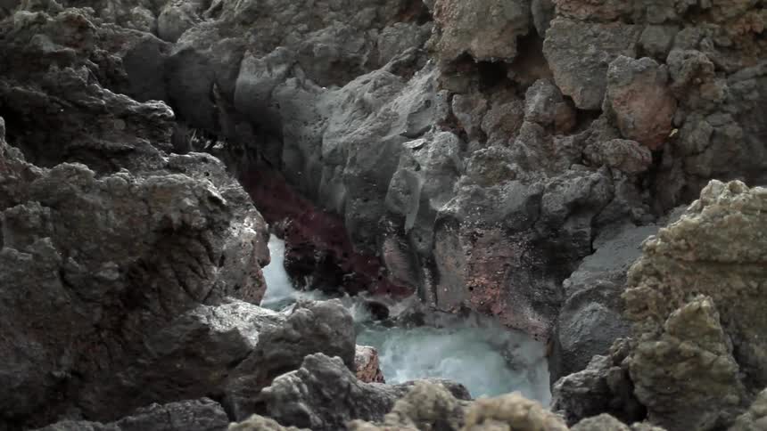 Water is flowing between this rocky canyon