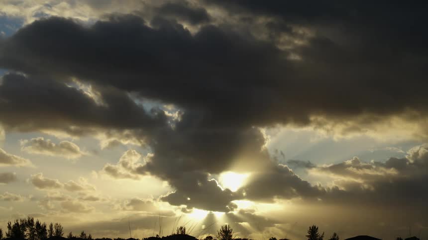 Clouds roll over the rising sun