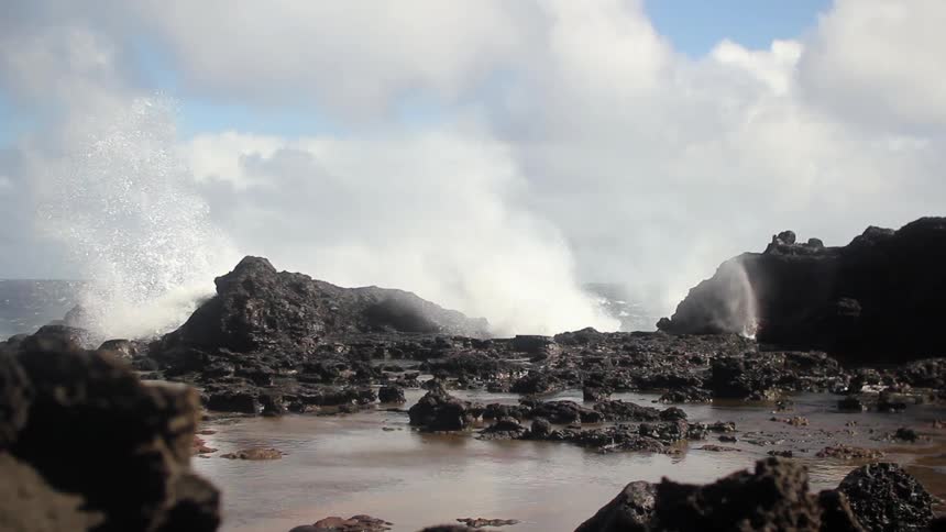 Waves crash onto a rocky shore