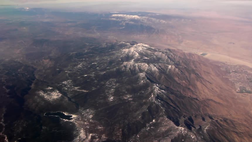 The mountain range below has snow on the tip