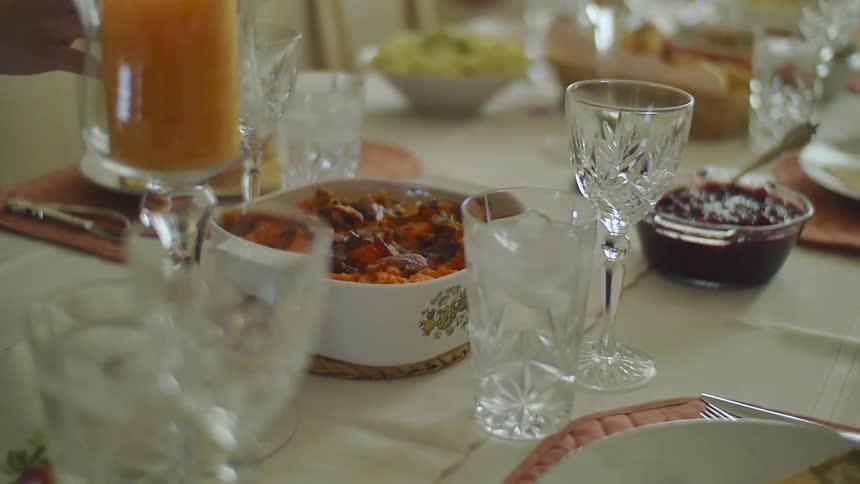 A person places a glass on the table