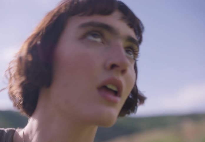 Portrait of a woman dancing in a field