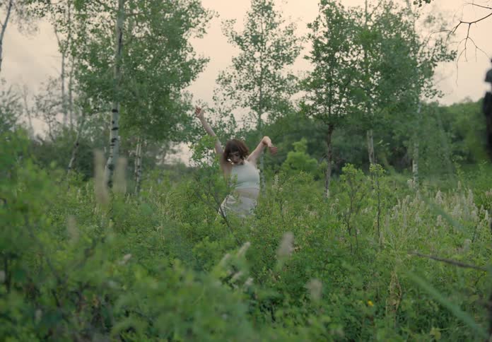 Woman dancing in the midst of nature